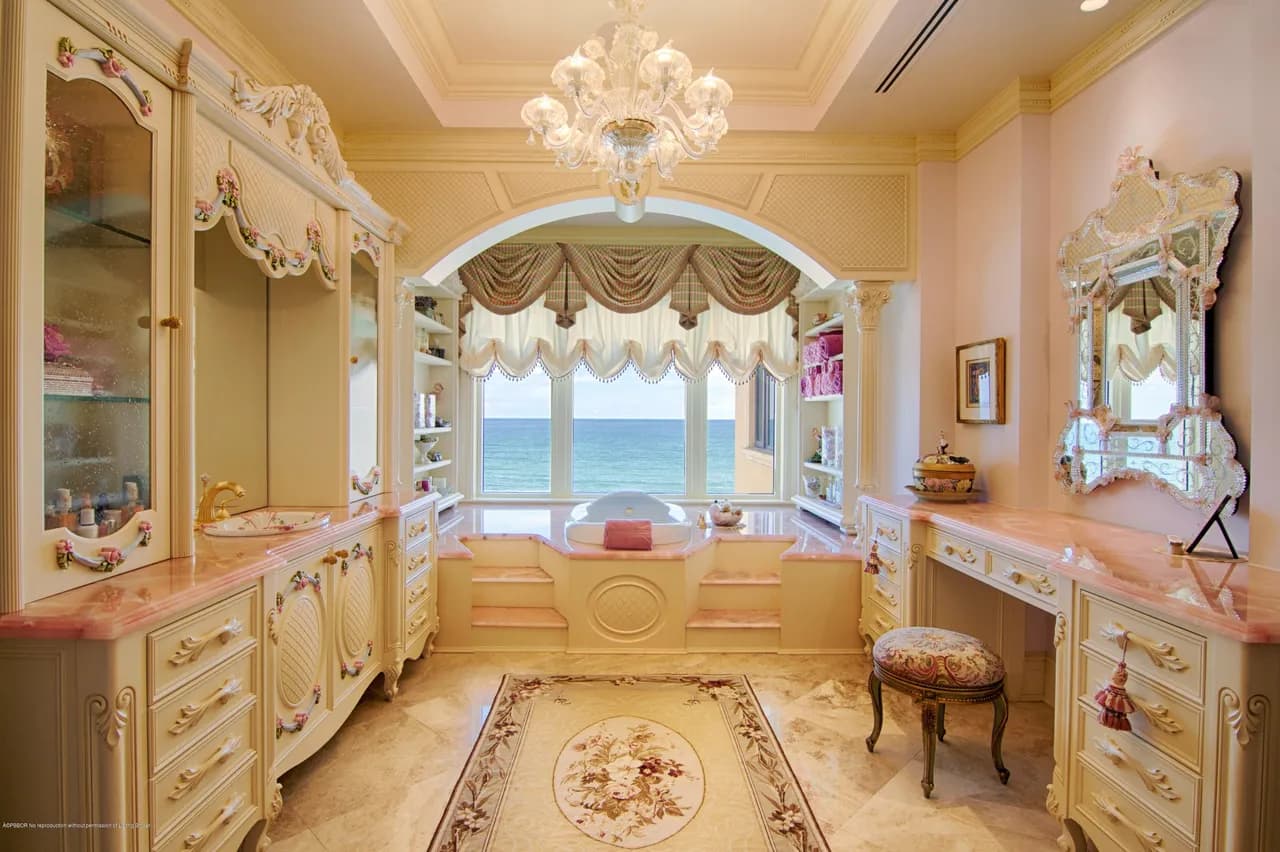 Ornate master bath with pink marble and ocean view tub